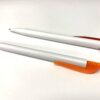 White pen with orange clip and white pen with red clip